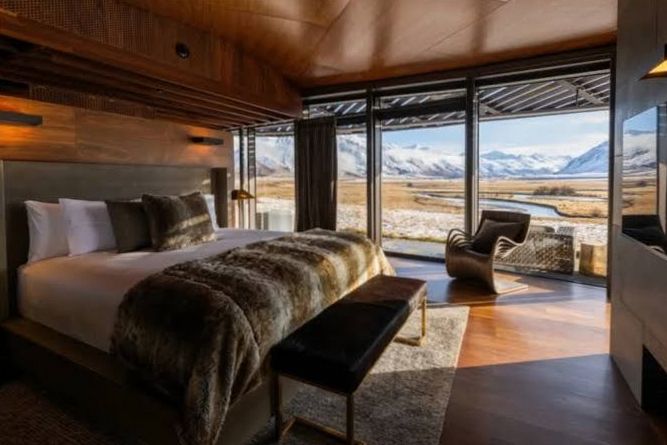 Luxury suite balcony at dusk overlooking Lake Wakatipu and The Remarkables